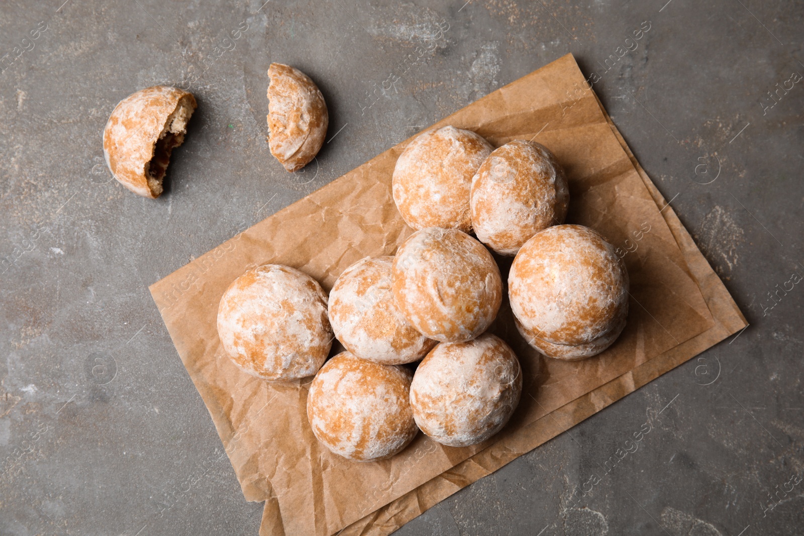 Photo of Tasty homemade gingerbread cookies on grey table, flat lay