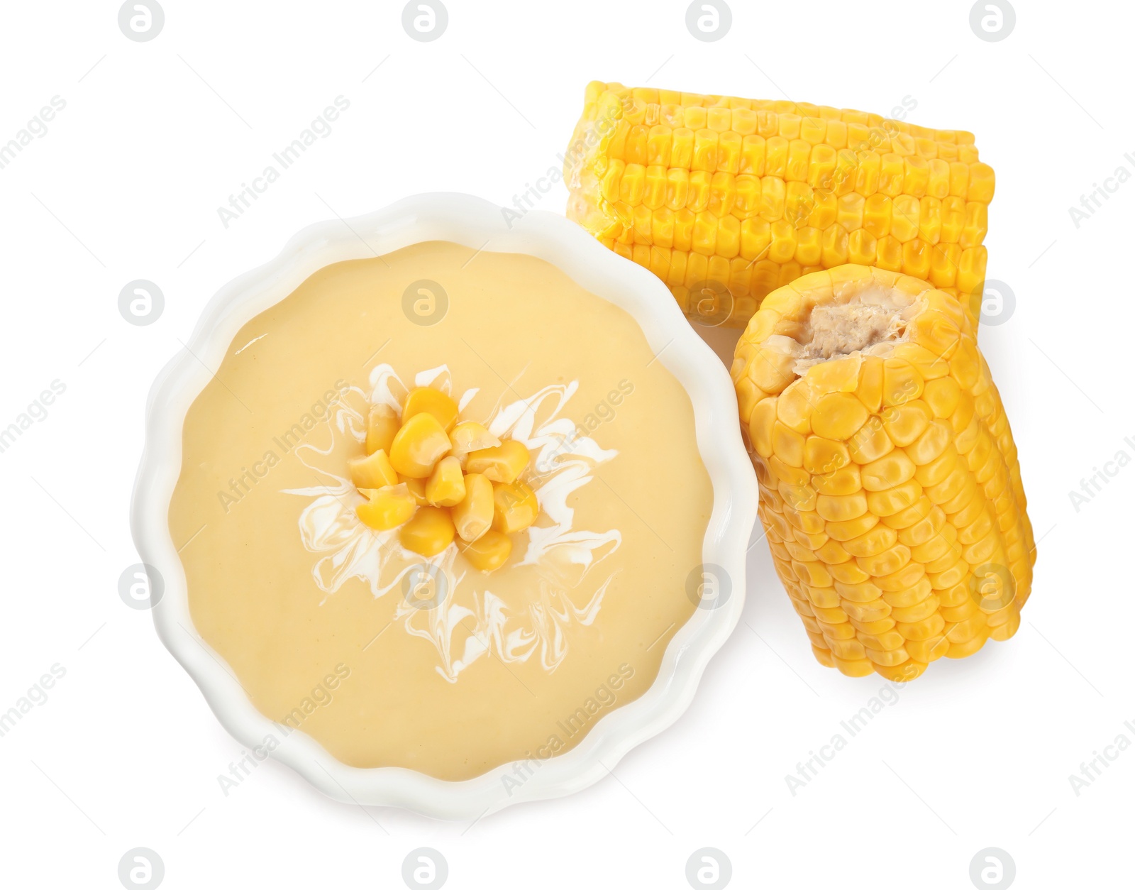 Photo of Delicious corn cream soup and cobs on white background, top view