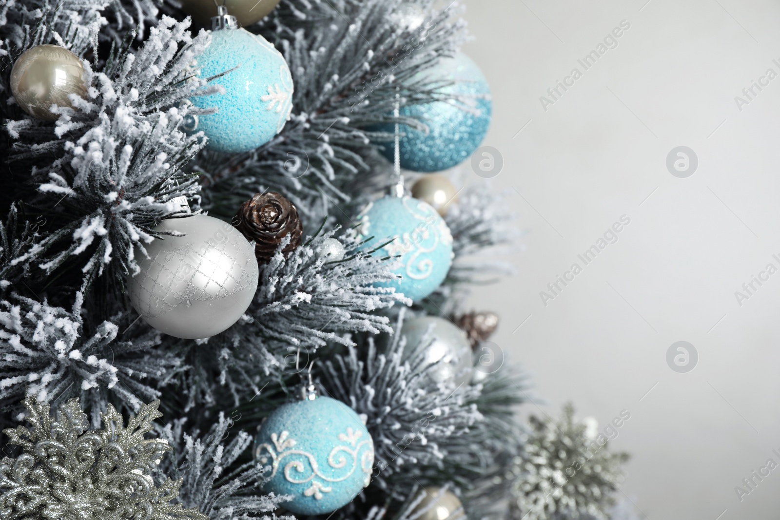 Photo of Beautiful Christmas tree with decor against light grey background, closeup. Space for text