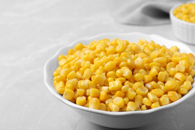 Delicious canned corn in bowl on marble table, closeup