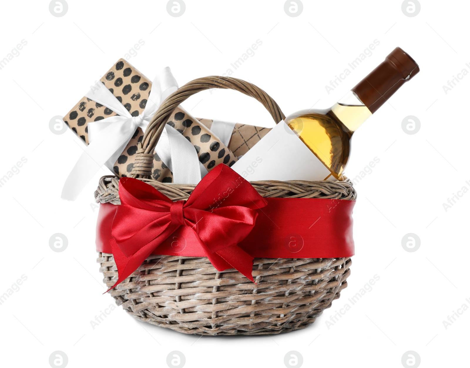 Photo of Festive basket with bottle of wine and gifts on white background