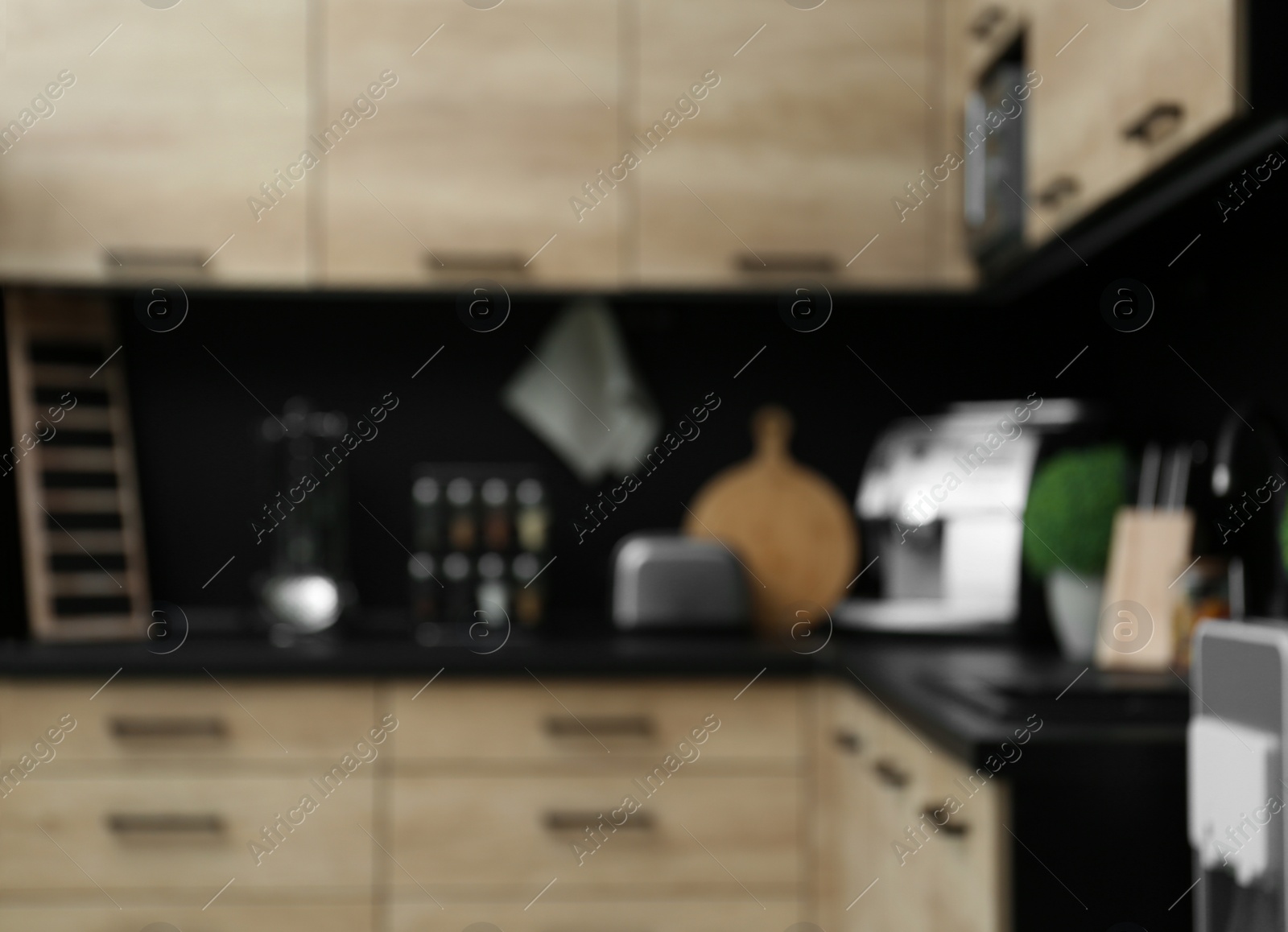 Photo of Blurred view of kitchen interior with modern furniture