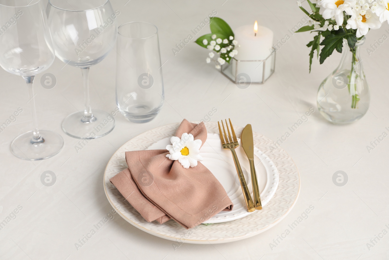 Photo of Elegant festive setting with floral decor on white table