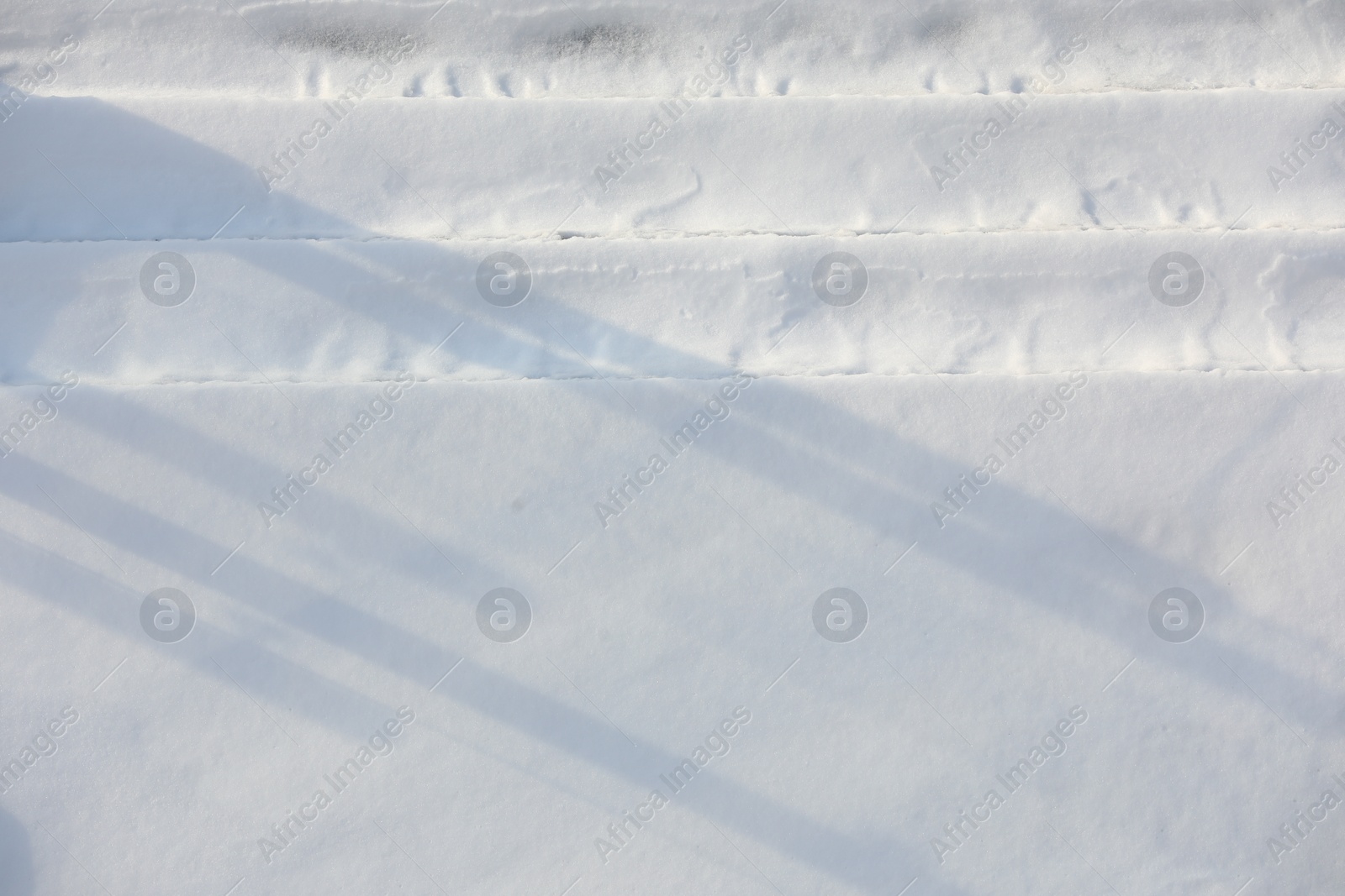 Photo of Car tire tracks on snow outdoors. Winter season