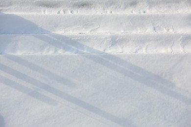 Car tire tracks on snow outdoors. Winter season