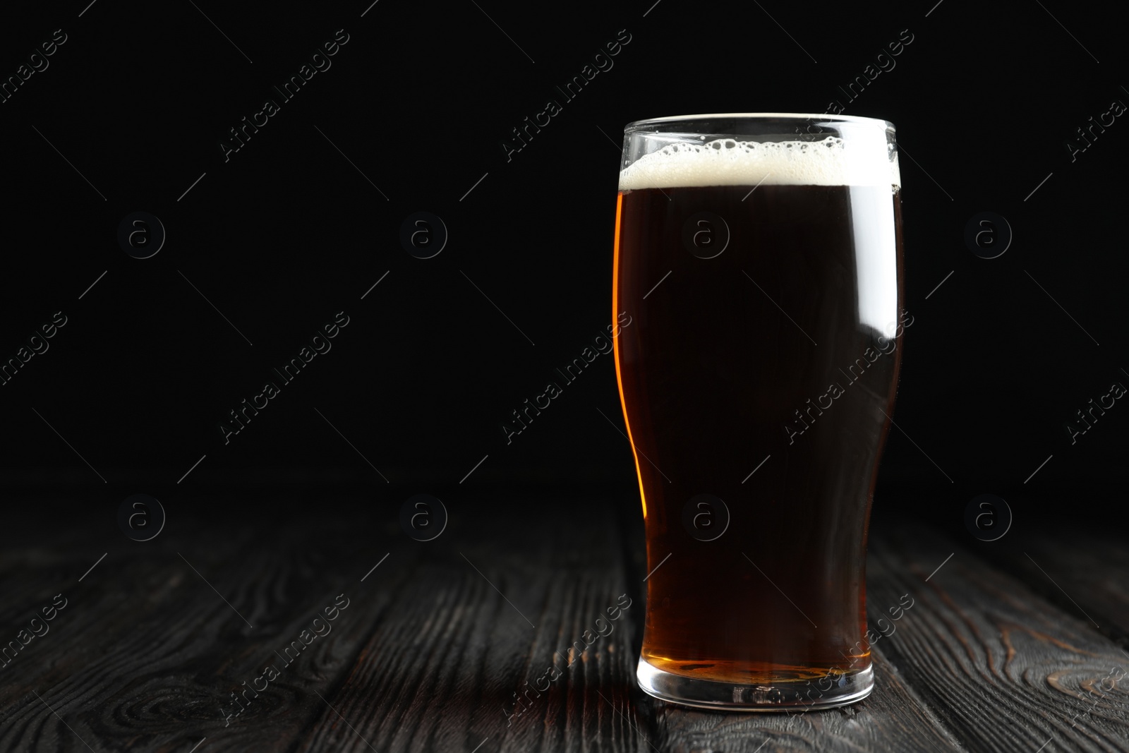 Photo of Glass of delicious kvass on wooden table. Space for text