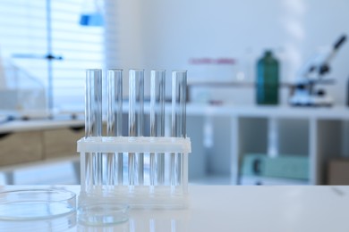 Photo of Laboratory analysis. test tubes and petri dishes on white table indoors, space for text