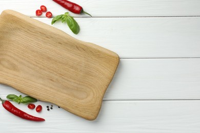 Photo of Cutting board and different spices on white wooden table, flat lay. Space for text