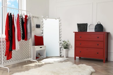 Dressing room with stylish clothes, shoes and accessories. Elegant interior design