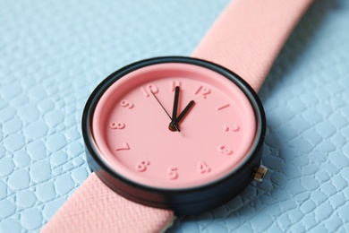 Photo of Stylish wrist watch on color background, closeup. Fashion accessory