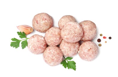 Many fresh raw meatballs with parsley and spices on white background, top view