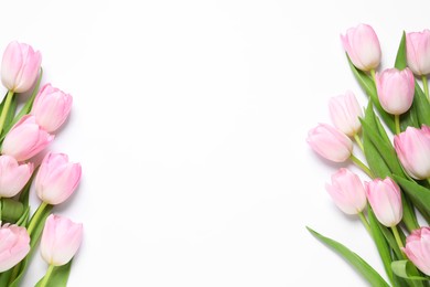 Photo of Beautiful pink spring tulips on white background, top view. Space for text