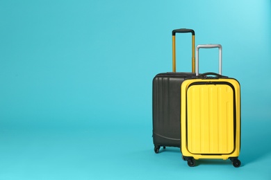 Photo of Stylish suitcases on color background. Space for text