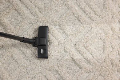 Image of Hoovering carpet with vacuum cleaner, top view and space for text. Clean trace on dirty surface