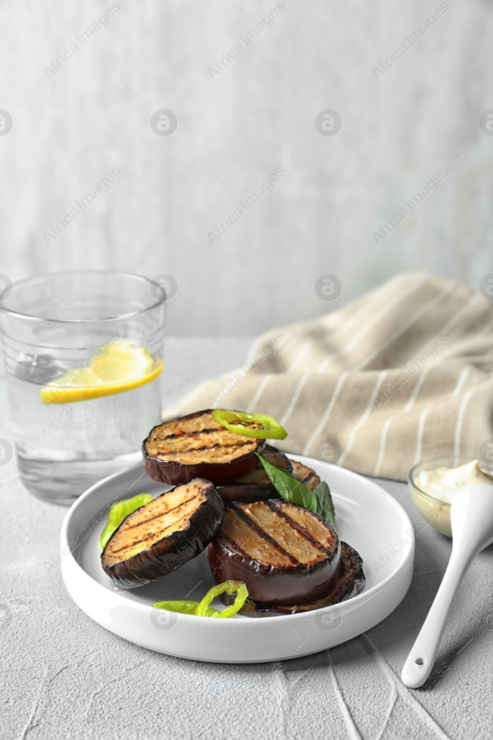 Photo of Plate with fried eggplant slices on table