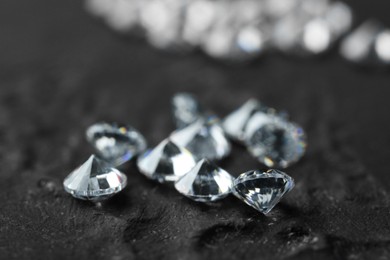 Many beautiful shiny diamonds on dark background