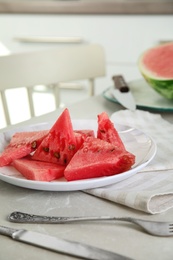 Photo of Yummy watermelon slices on table in kitchen