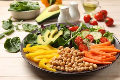 Balanced diet and vegetarian foods. Plate with different delicious products on wooden table, closeup