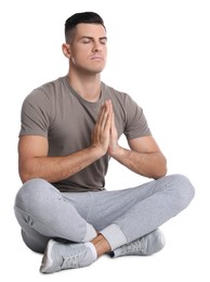 Photo of Handsome man meditating on white background. Harmony and zen