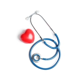 Stethoscope and heart model on light background, top view. Medical equipment