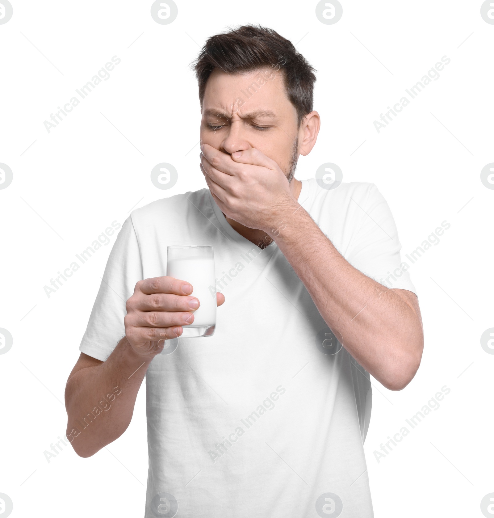 Photo of Man with glass of milk suffering from lactose intolerance on white background