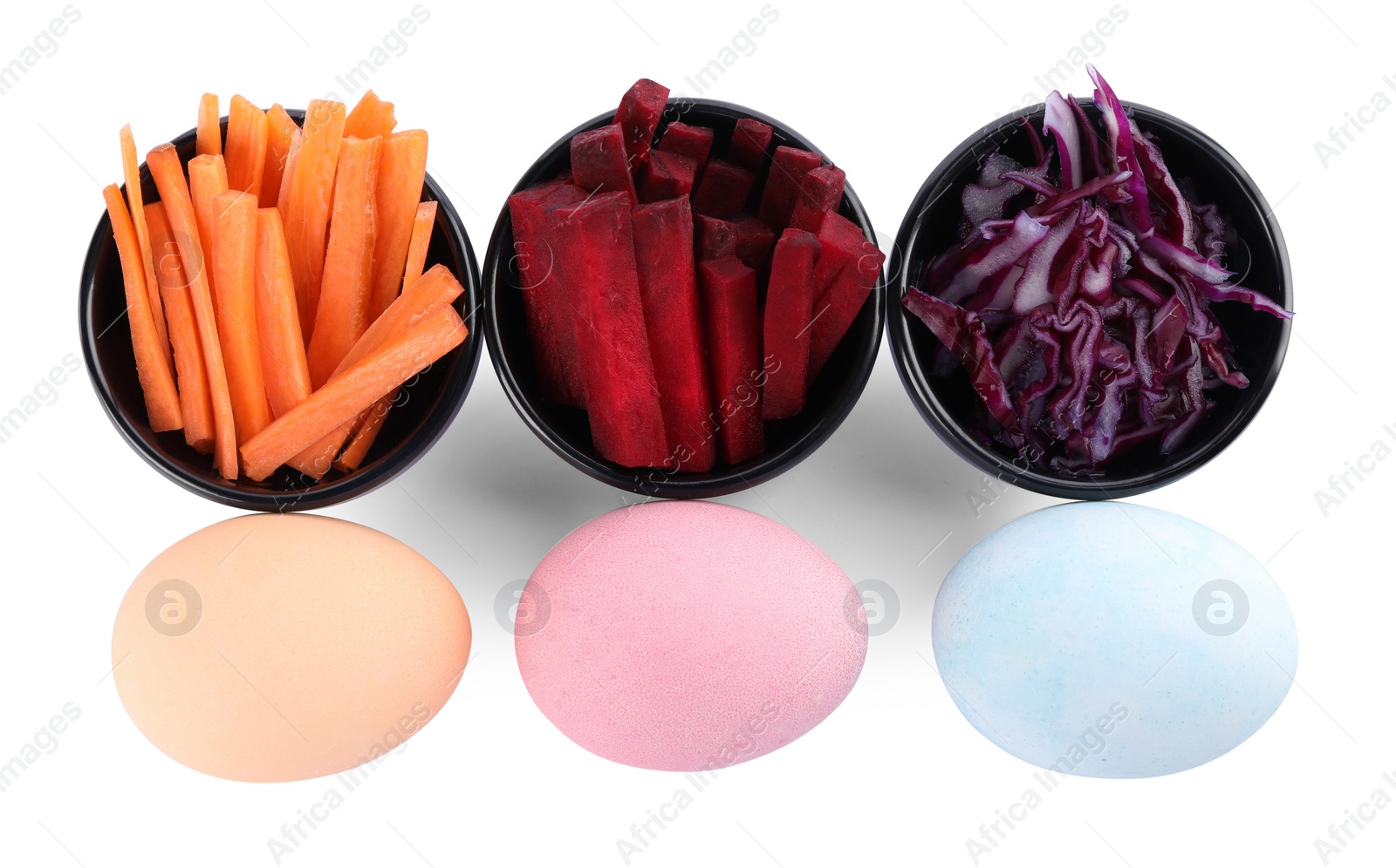 Photo of Naturally painted Easter eggs on white background, top view. Carrot, beetroot and red cabbage used for coloring