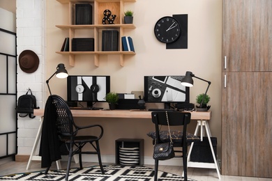 Stylish workplace interior with computers on table