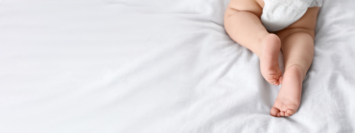 Image of Cute little baby lying on bed, space for text. Banner design