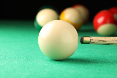 Photo of Classic plain billiard ball and cue on green table