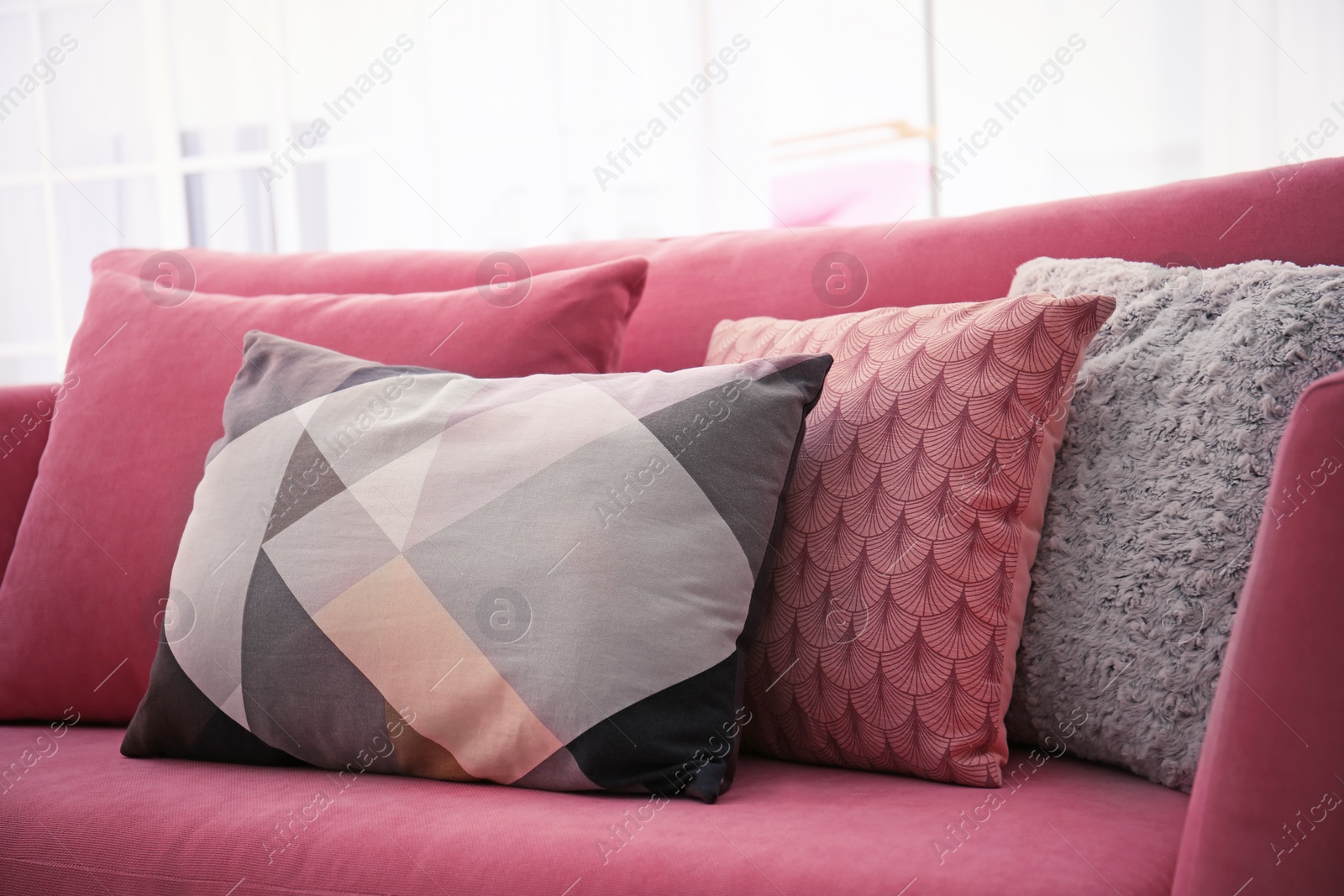 Photo of Sofa with colorful pillows in living room