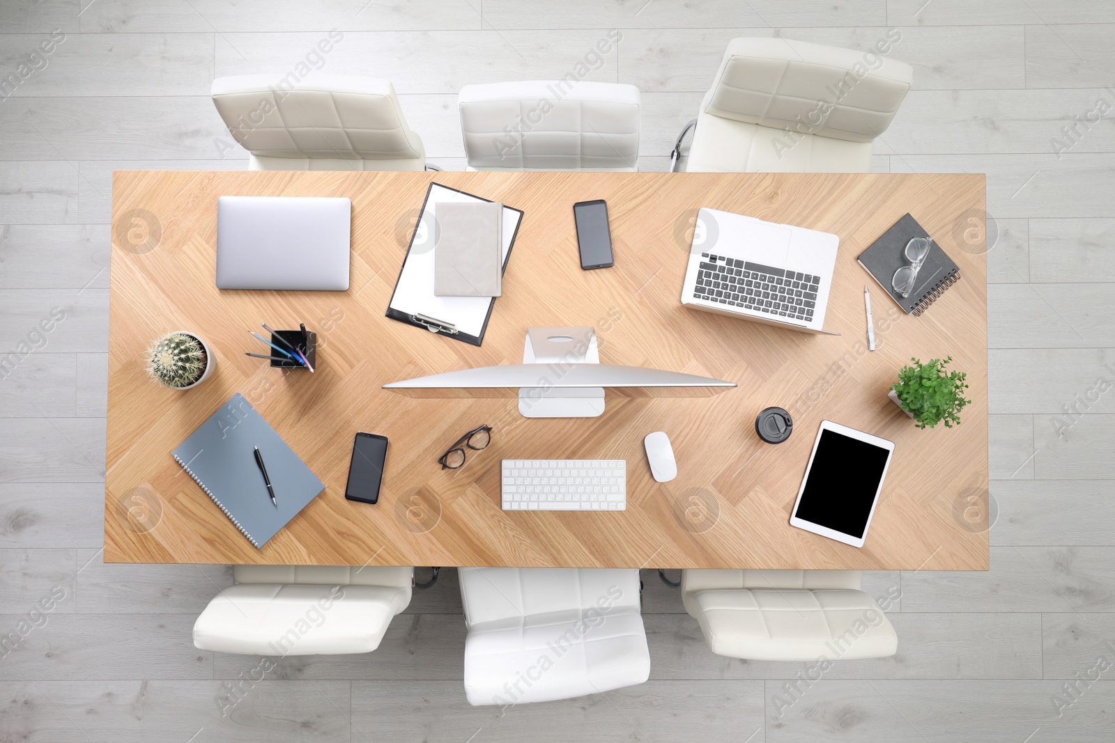 Photo of Modern office table with devices and chairs, top view