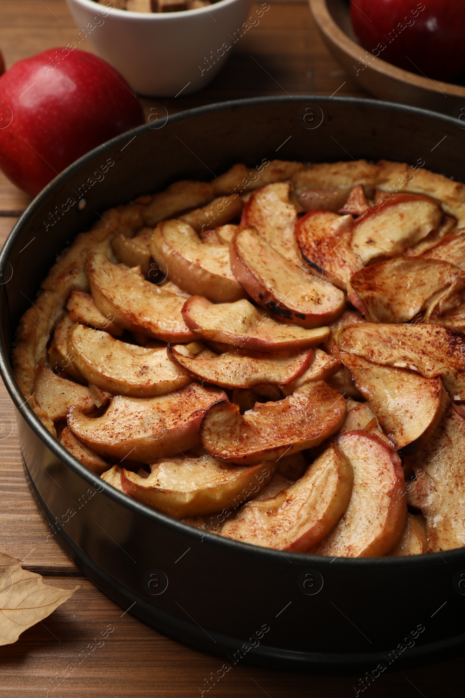 Photo of Delicious apple pie on wooden table, closeup