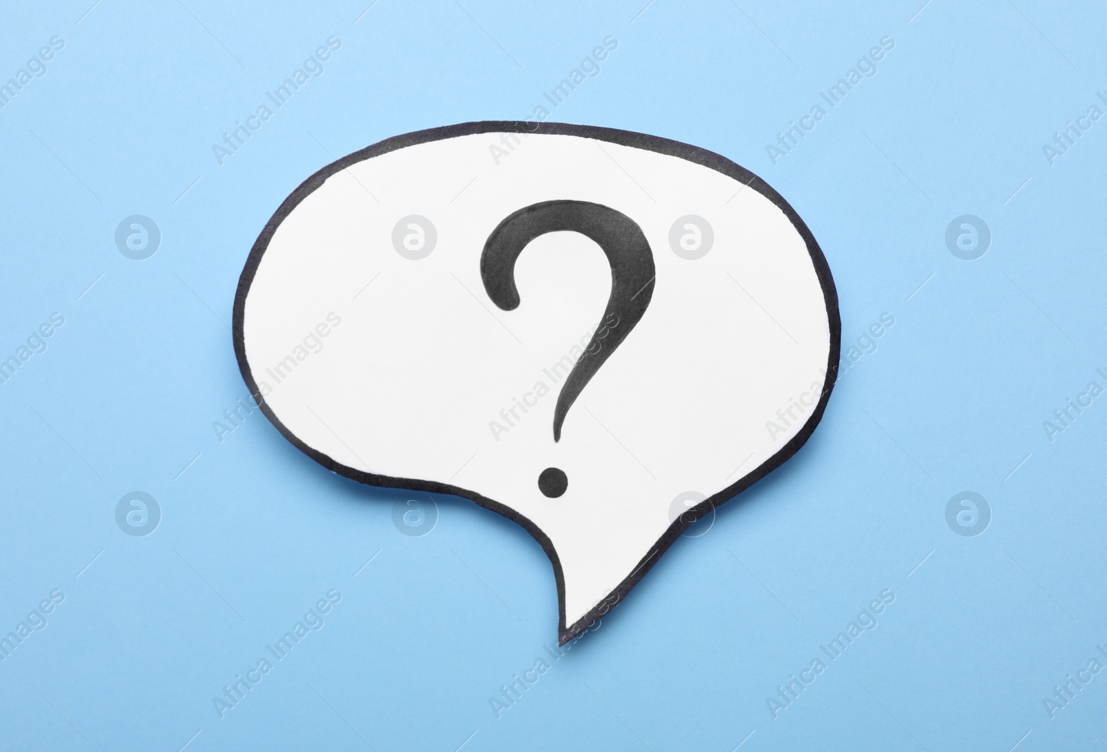 Photo of Paper speech bubble with question mark on light blue background, top view