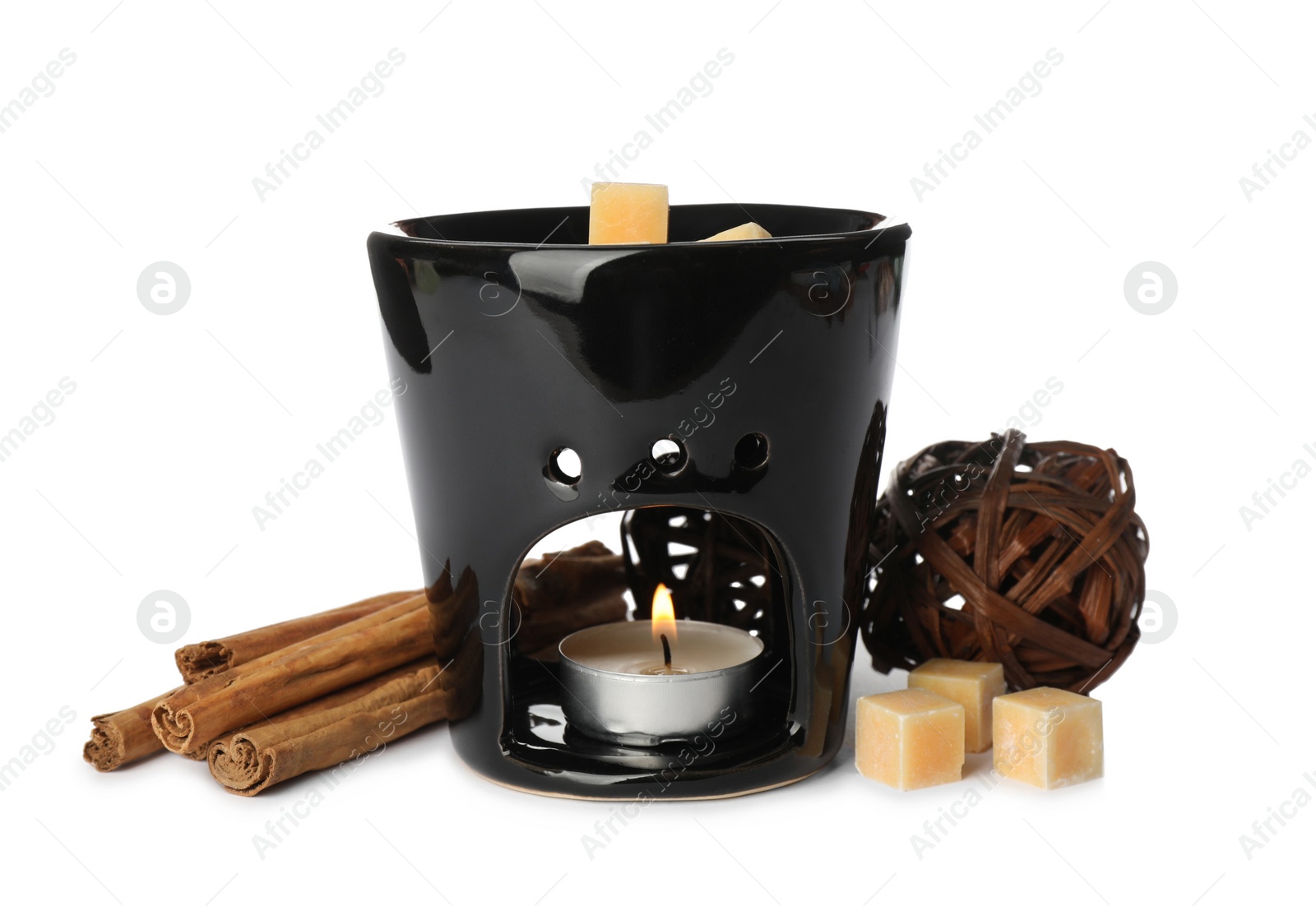 Photo of Stylish aroma lamp with essential wax cubes and cinnamon on white background