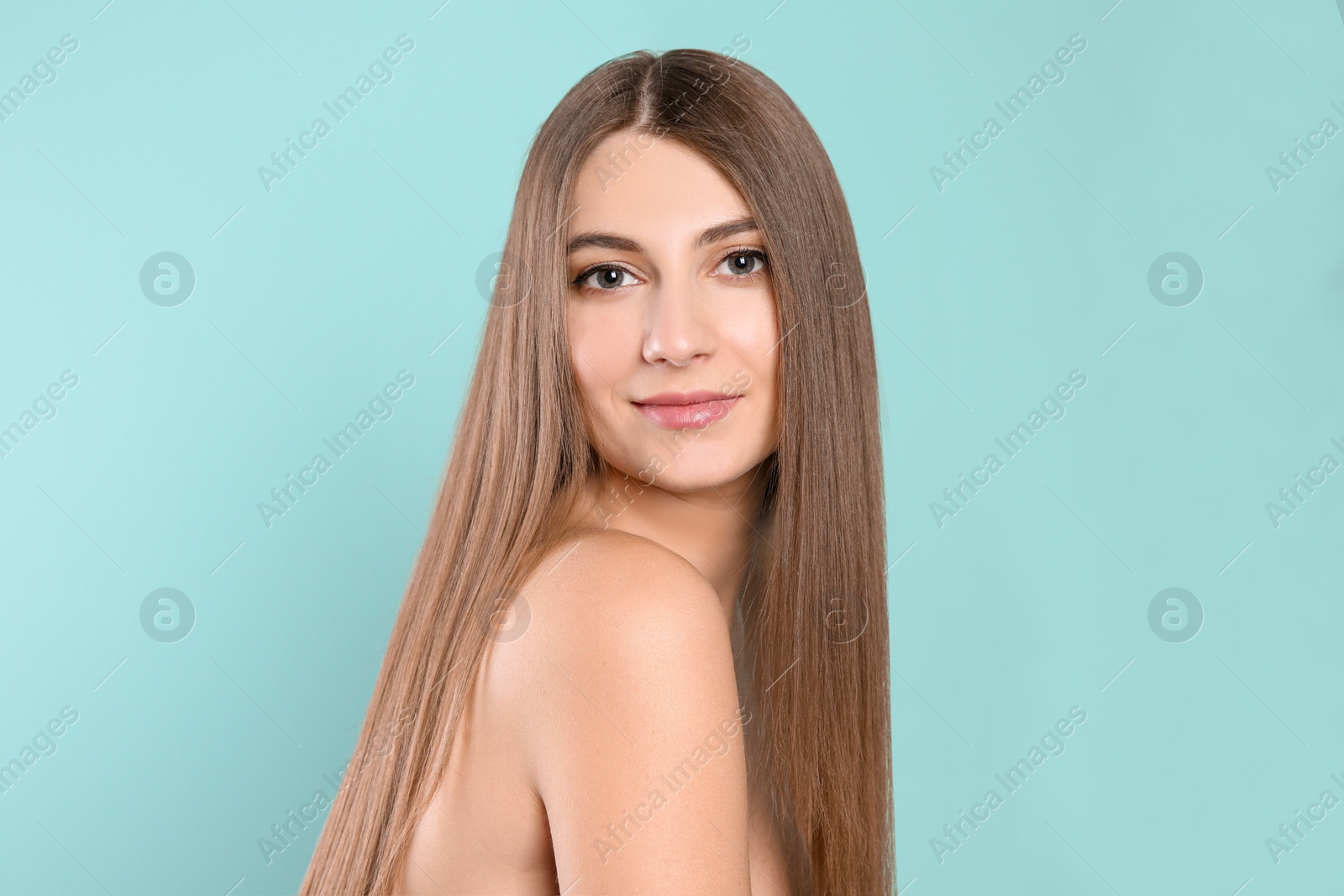 Photo of Portrait of young woman with long beautiful hair on color background