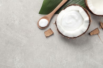 Photo of Ripe coconut and cream on light grey table, flat lay. Space for text