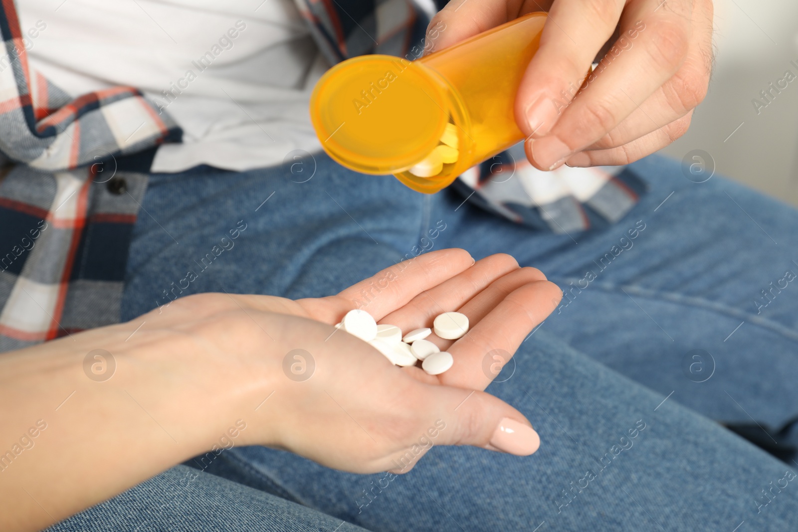 Photo of Man giving medicine to woman, closeup view