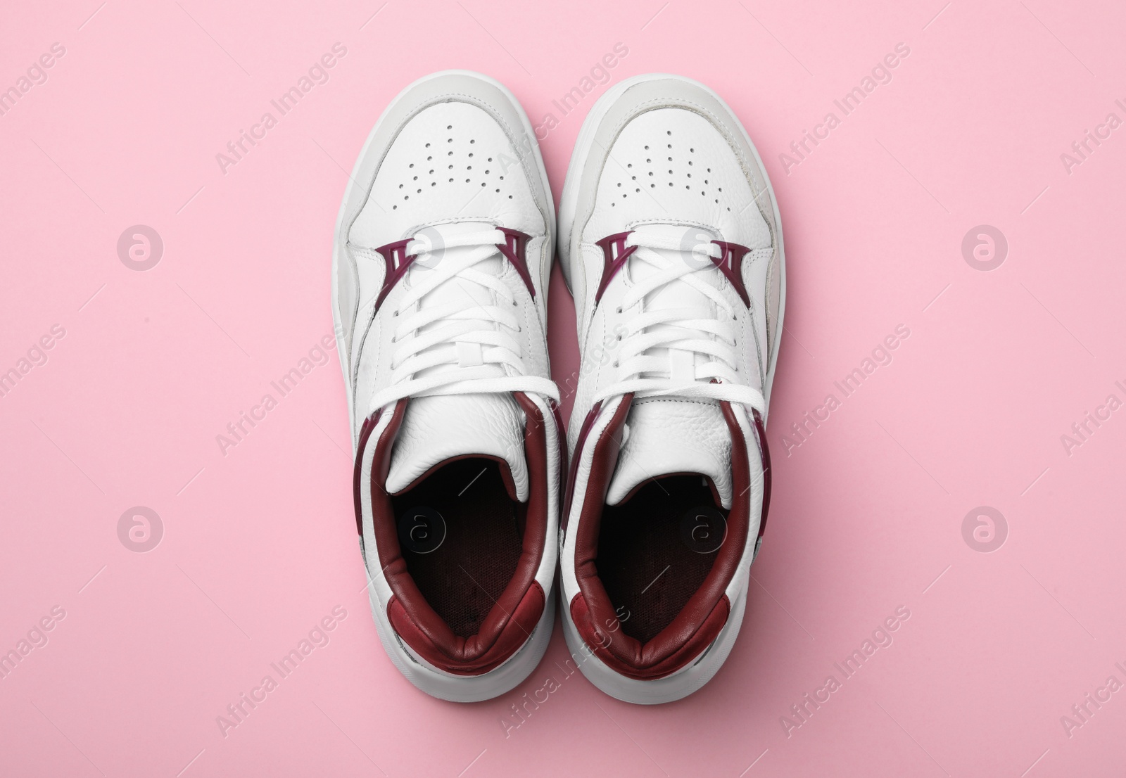 Photo of Pair of stylish shoes on pink background, top view