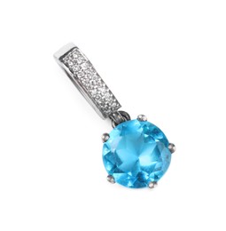 Photo of Elegant silver pendant with light blue gemstone isolated on white, top view. Luxury jewelry