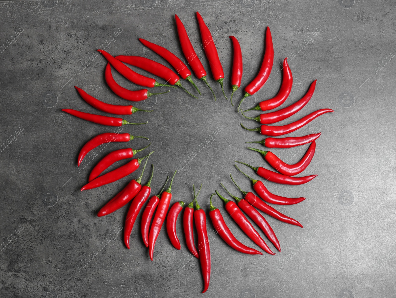 Photo of Flat lay composition with chili peppers on grey background