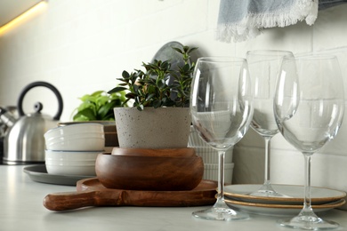 Set of clean tableware on white countertop in kitchen