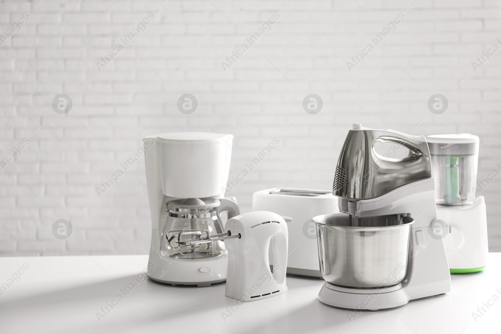 Photo of Set of modern home appliances on white table