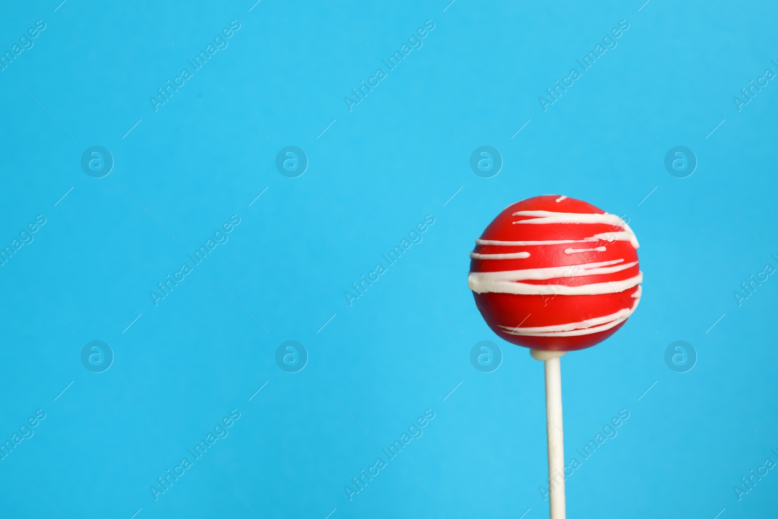 Photo of Bright delicious cake pop on color background. Space for text