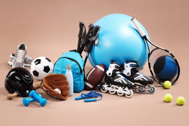 Photo of Many different sports equipment on beige background