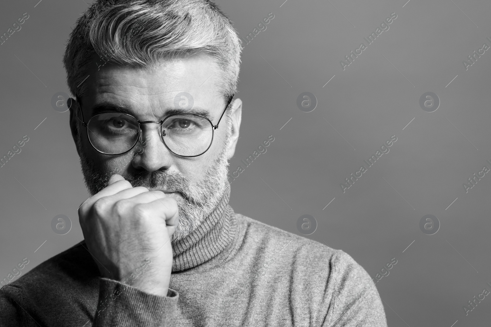 Photo of Portrait of handsome man on grey background, space for text. Black and white effect