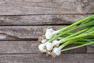 Photo of Fresh garlic bulbs on wooden background, top view