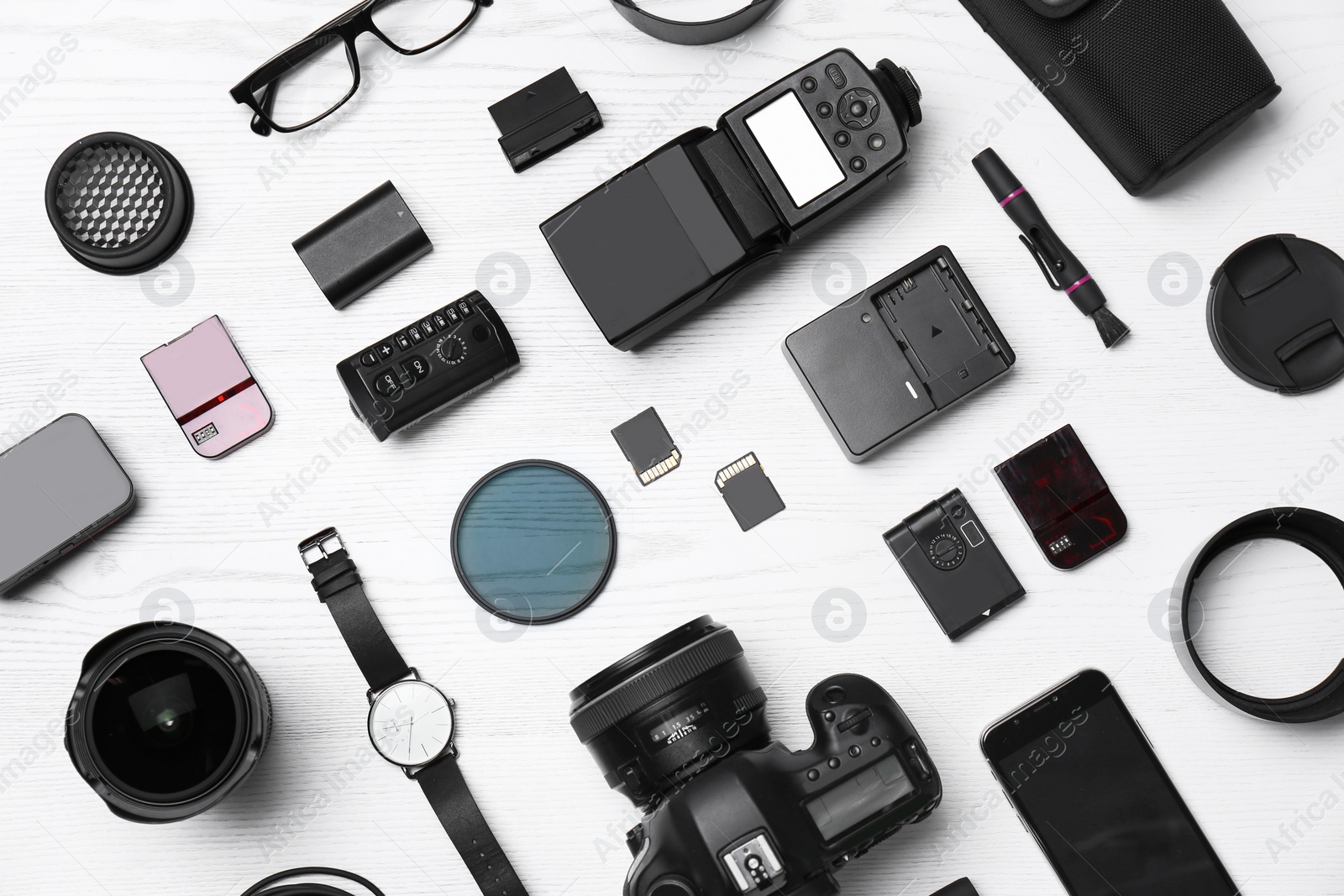 Photo of Flat lay composition with equipment for professional photographer on wooden background