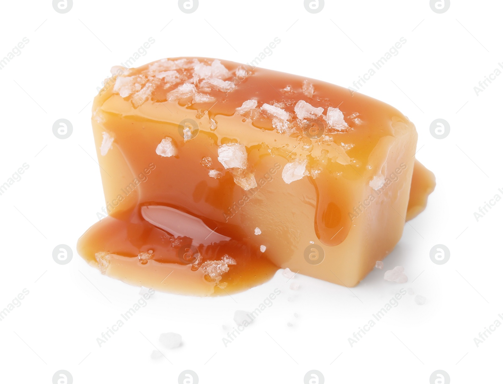 Photo of Yummy caramel candy and sea salt isolated on white