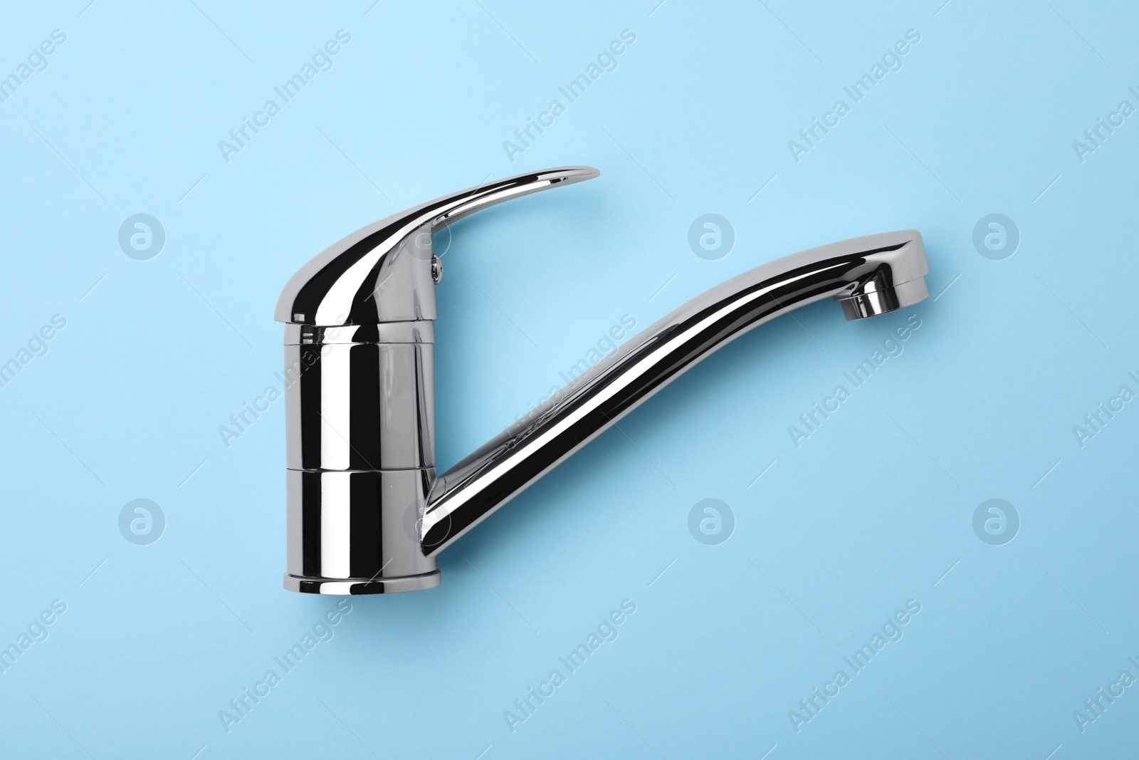 Photo of Single handle water tap on light blue background, top view