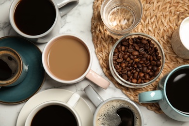 Photo of Flat lay composition with cups of coffee on marble background. Food photography